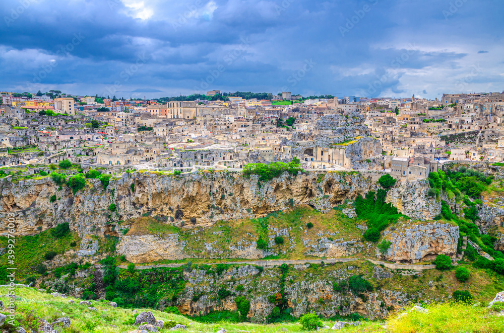 Panorama od Matera town historical centre Sasso Caveoso old ancient town Sassi di Matera with cave rock houses, blue dramatic sky, view from Murgia Timone, UNESCO Heritage, Basilicata, Southern Italy