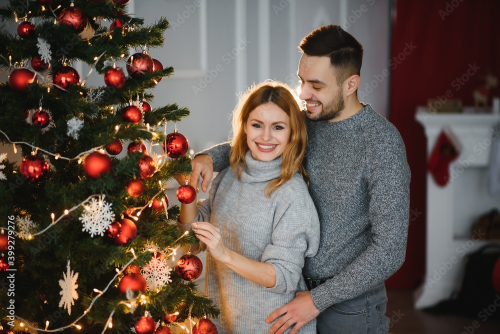 Romantic couple in love feeling happiness about their romance spending christmas eve together, woman and man enjoying perfect relationships and spending winter vacations in cozy home interior Romantic couple in love feeling happiness about their romance spending christmas eve together, woman and man enjoying perfect relationships and spending winter vacations in cozy home interior