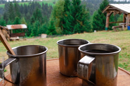 Morning coffee in metal cups at an alpine camping