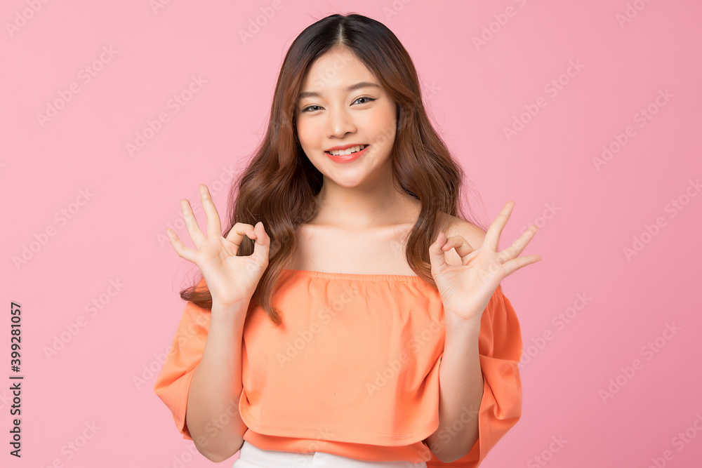 Cute young woman posing happily portrait isolated on pink studio background Cute young woman posing happily portrait isolated on pink studio background
