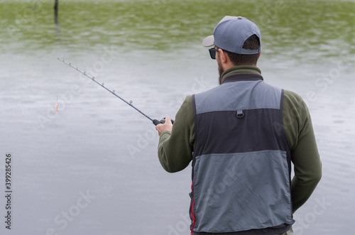 Black bass fisherman fishing inside lake