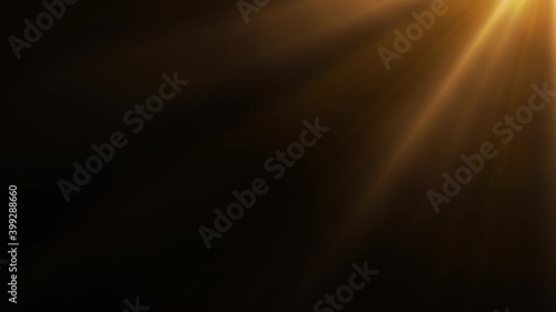 Animated golden light rays on dark background photo