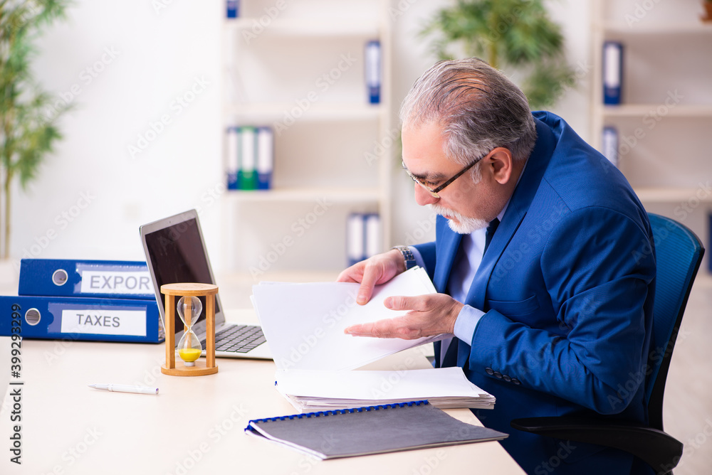 Old male employee businessman in time management concept Old male employee businessman in time management concept