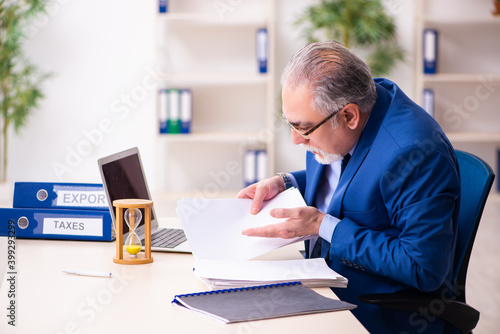 Old male employee businessman in time management concept
