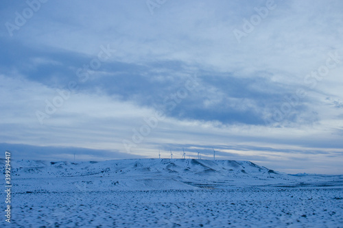 Winter landscape. View of the steppes covered with snow, on which there are wind turbines