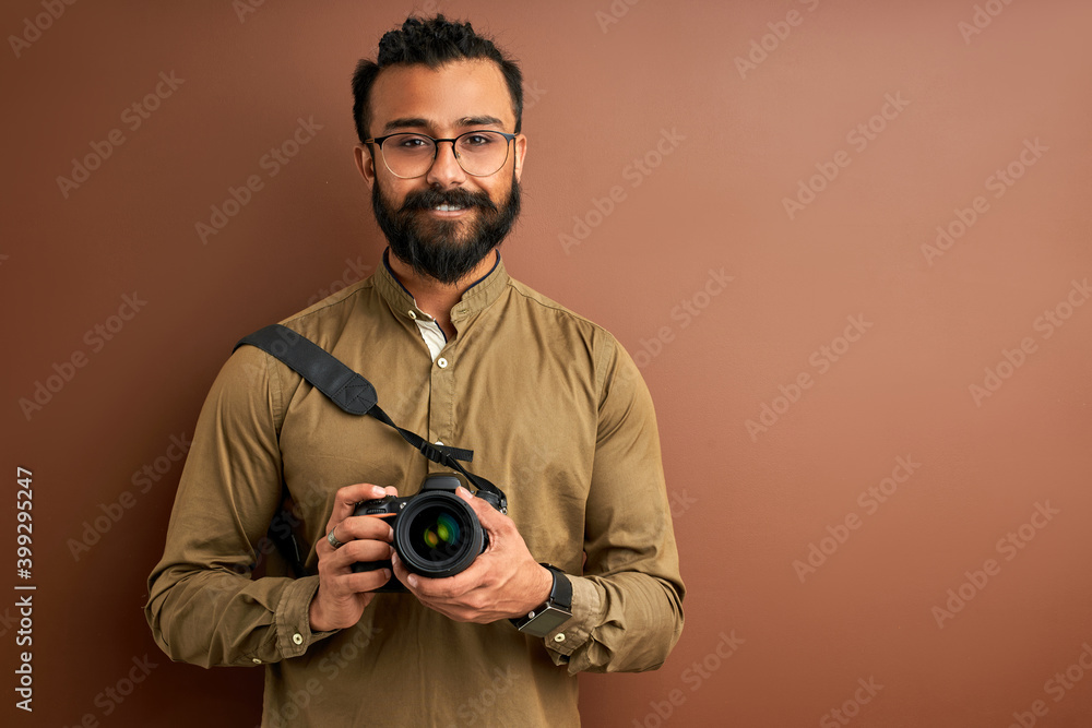 arab man taking photo on camera, holding professional camera in hands, wearing shirt. posing. creativity and photography concept arab man taking photo on camera, holding professional camera in hands, wearing shirt. posing. creativity and photography concept