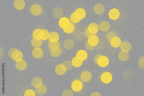 Golden bokeh background. Bright blurred texture of lights. Trendy colors 2021 - Gray and Yellow