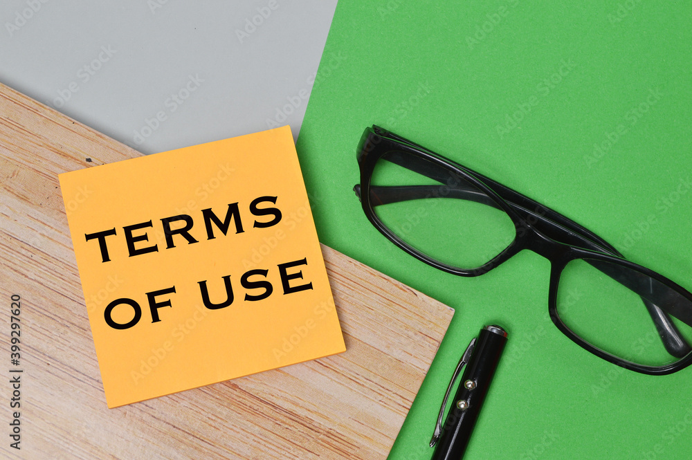 Top view of eyeglasses, pen, notebook and memo note written with text TERMS OF USE. Business and education concept. Top view of eyeglasses, pen, notebook and memo note written with text TERMS OF USE. Business and education concept.