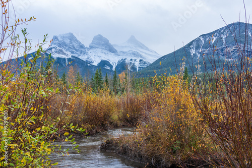 Snow capped The Three Sisters trio peaks mountain in autumn. Beautiful natural scenery landscape at Canmore, Canadian Rockies, Alberta, Canada.
