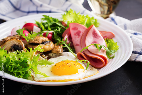 English breakfast - fried eggs, ham, fried mushrooms, radish and arugula. ketogenic, keto food.