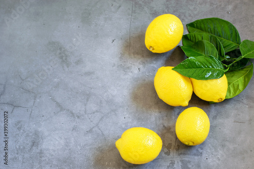 Group of fresh yellow lemons on the gray background. Healthy fruit for eating. Top view  copy space.