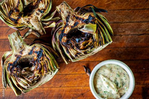 Grilled artichokes. Sautéed organic vegetable in olive oil, herbs, spices and salt and pepper. Classic American steakhouse, restaurant or French bistro side dish.
