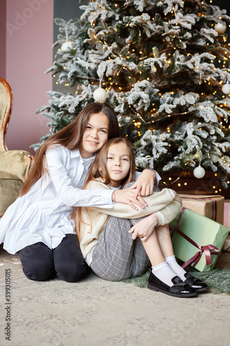 Portrait of happy family with Christmas gifts on floor at home