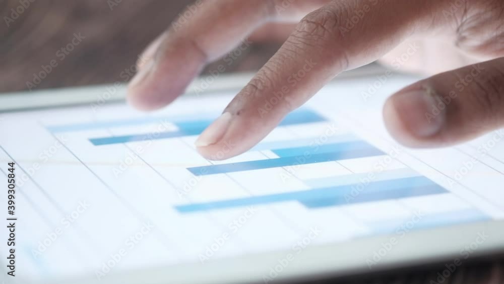man's hand analyzing bar chart and on digital tablet man's hand analyzing bar chart and on digital tablet