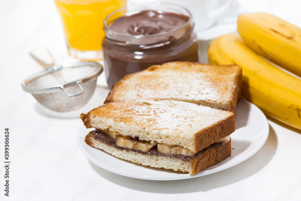 sweet sandwich with chocolate paste and banana for breakfast on white table sweet sandwich with chocolate paste and banana for breakfast on white table