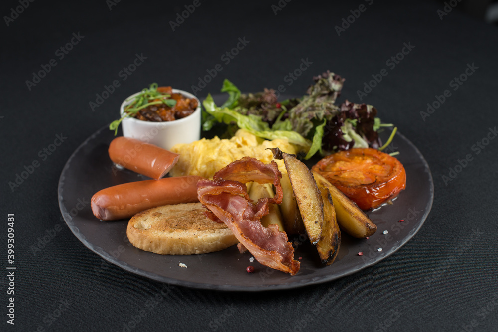 Traditional English breakfast. Sausage, beans, eggs, bread and salad Traditional English breakfast. Sausage, beans, eggs, bread and salad