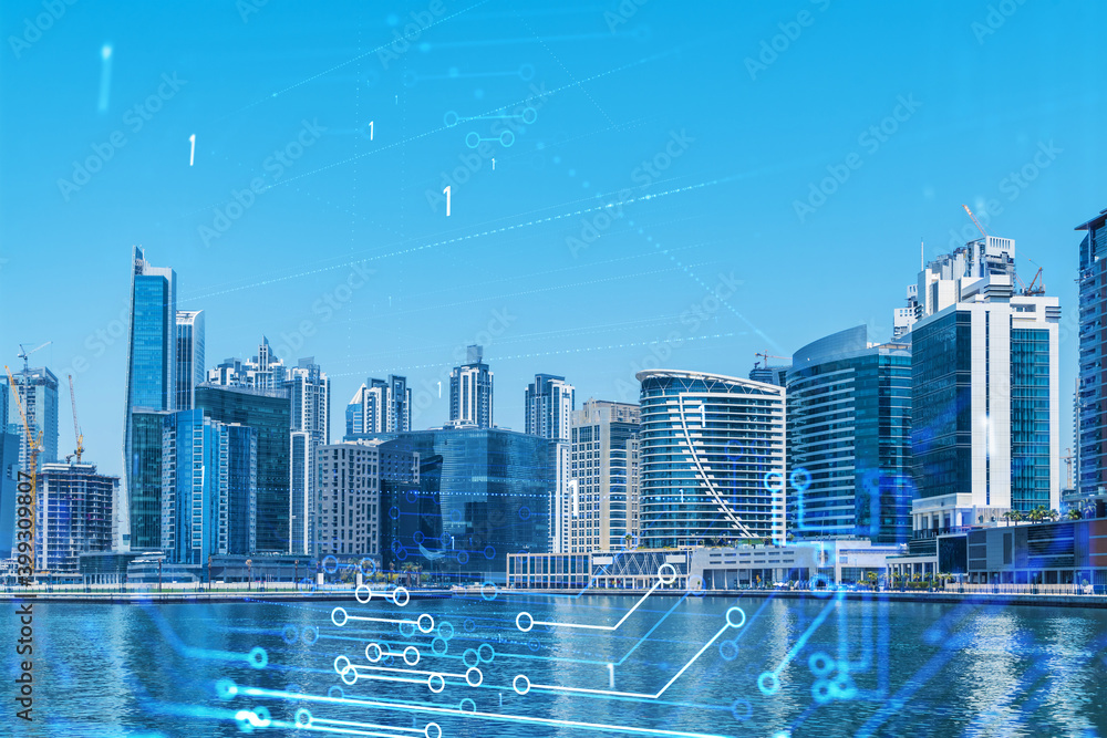 Fototapeta premium Skyscrapers of Dubai business downtown. International hub of trading and financial services. Technology theme icons hologram, Fintech concept. Double exposure. Dubai Canal waterfront.