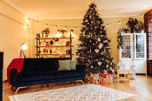Beautiful festively decorated room with a Christmas tree with gifts below