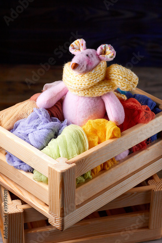 Pink plush fuuny mouse doll sitting in wooden box