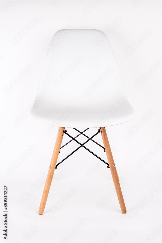 Modern white plastic chair with wooden legs isolated on a white background Modern white plastic chair with wooden legs isolated on a white background