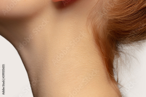 Neck. Close up portrait of beautiful redhair caucasian female model. Parts of face. Beauty  fashion  skincare  cosmetics  wellness concept. Copyspace. Well-kept skin  fresh look  details.