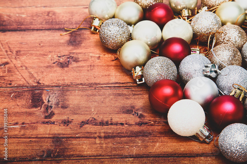 Gold,silver and red christmas baubles on a wooden background with space for copy and a matte filter applied