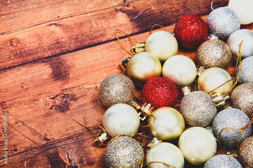 Gold,silver and red christmas baubles on a wooden background with space for copy and a matte filter applied