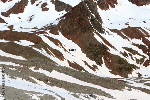 Wallpaper Mural Drone flying in front of mountain snow panorama and blue sky in Tyrol Alps, Austria Torontodigital.ca