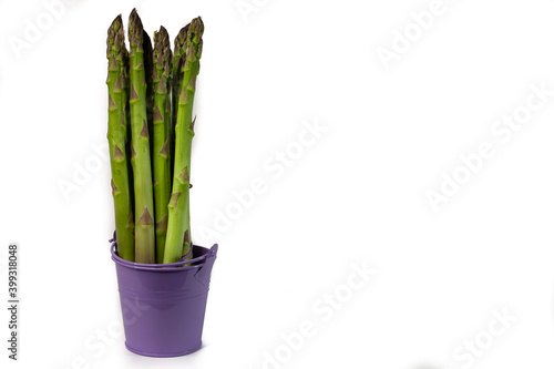 Green asparagus in purple bowl