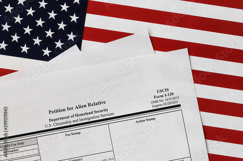 close-up of i-130 form. petition for alien relative topview, on a background of United States flag.