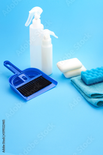 Household chemicals products and Supplies on Blue Background. Cleaning Services. Washing equipment sponge, rag, soap