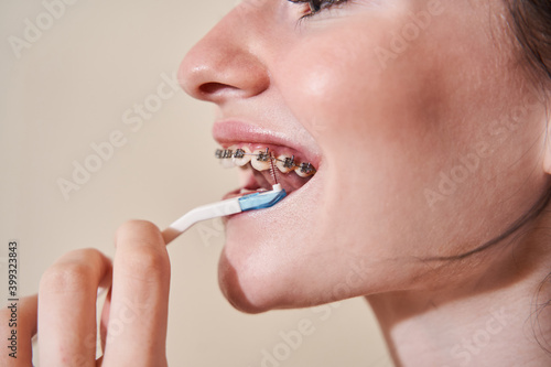 Woman cleaning and brushing teeth