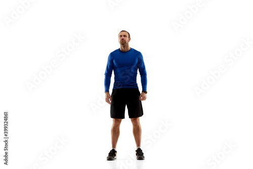Ready. Caucasian professional jogger, runner training isolated on white studio background. Muscular, sportive man, emotional. Concept of action, motion, youth, healthy lifestyle. Copyspace for ad. © master1305