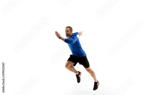 Fototapeta Naklejka Na Ścianę i Meble -  To top. Caucasian professional jogger, runner training isolated on white studio background. Muscular, sportive man, emotional. Concept of action, motion, youth, healthy lifestyle. Copyspace for ad.