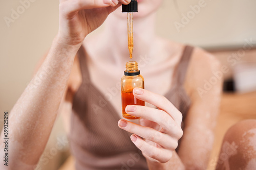 Woman preparing to putting cosmetic serum
