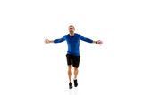 Expression. Caucasian professional jogger, runner training isolated on white studio background. Muscular, sportive man, emotional. Concept of action, motion, youth, healthy lifestyle. Copyspace for ad