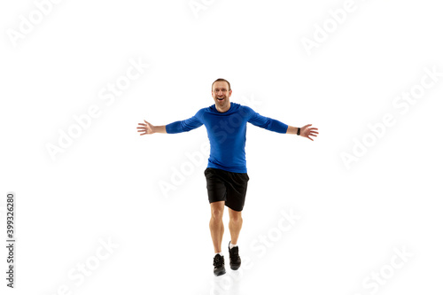 Fototapeta Naklejka Na Ścianę i Meble -  Expression. Caucasian professional jogger, runner training isolated on white studio background. Muscular, sportive man, emotional. Concept of action, motion, youth, healthy lifestyle. Copyspace for ad