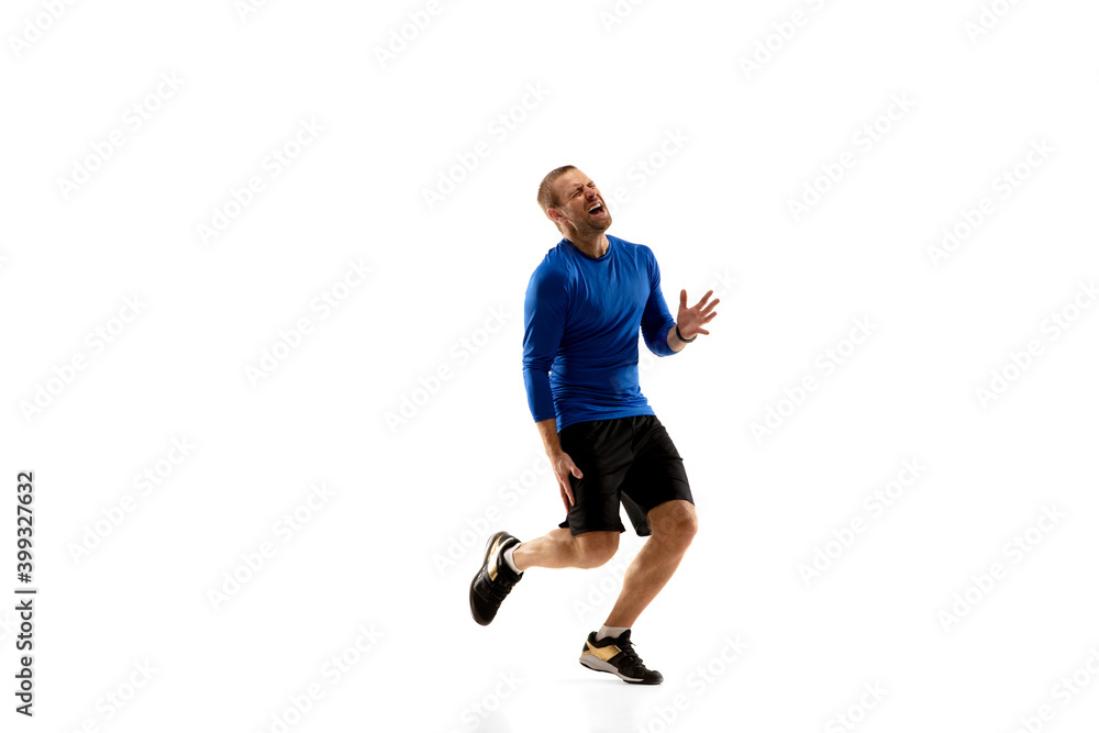 Pain. Caucasian professional jogger, runner training isolated on white studio background. Muscular, sportive man, emotional. Concept of action, motion, youth, healthy lifestyle. Copyspace for ad. Pain. Caucasian professional jogger, runner training isolated on white studio background. Muscular, sportive man, emotional. Concept of action, motion, youth, healthy lifestyle. Copyspace for ad.