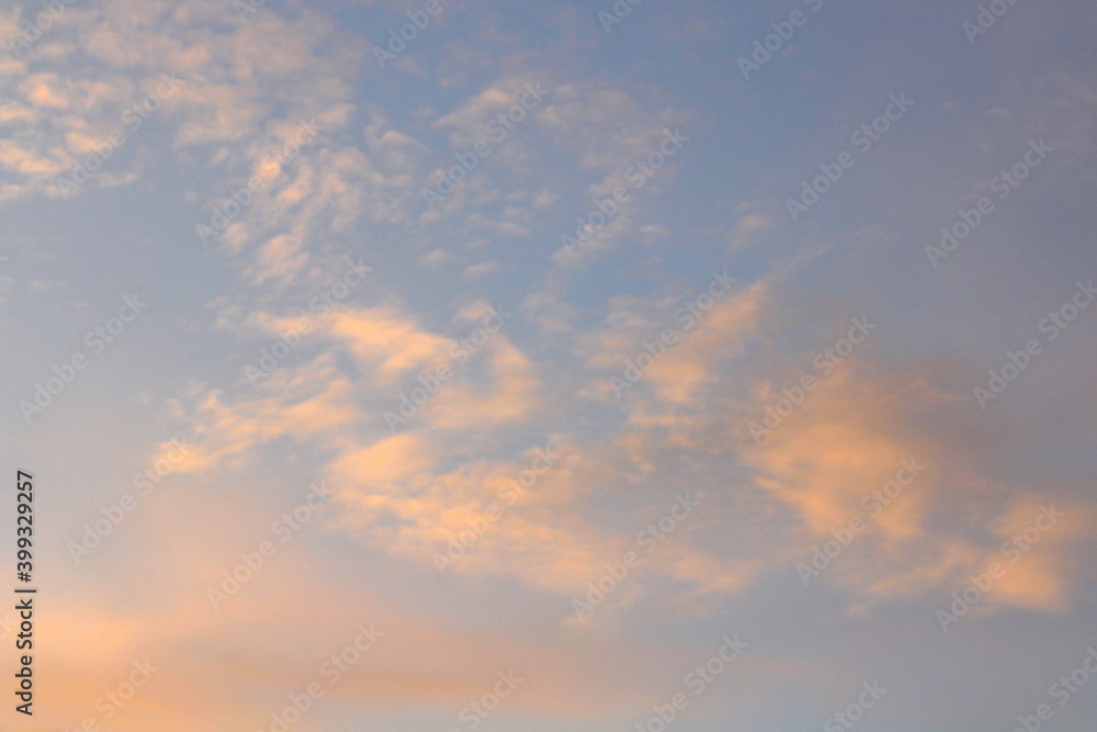 Pink clouds illuminated by the sun at dawn or sunset. Evening or morning dramatic sky
