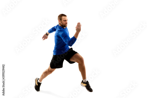 Power. Caucasian professional jogger  runner training isolated on white studio background. Muscular  sportive man  emotional. Concept of action  motion  youth  healthy lifestyle. Copyspace for ad.