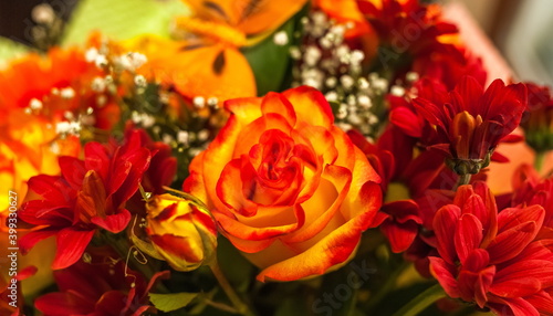 Bouquet of orange Roses and red Chrysanthemums close up
