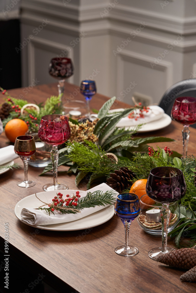 Christmas table setting with white plates and Christmas tree
