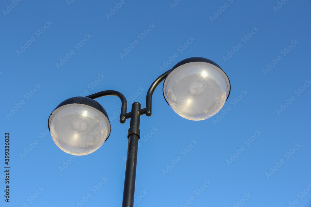 treet lamp made of two balls against the blue sky. Street lighting. treet lamp made of two balls against the blue sky. Street lighting.