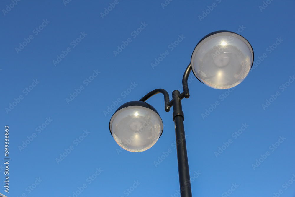 treet lamp made of two balls against the blue sky. Street lighting. treet lamp made of two balls against the blue sky. Street lighting.