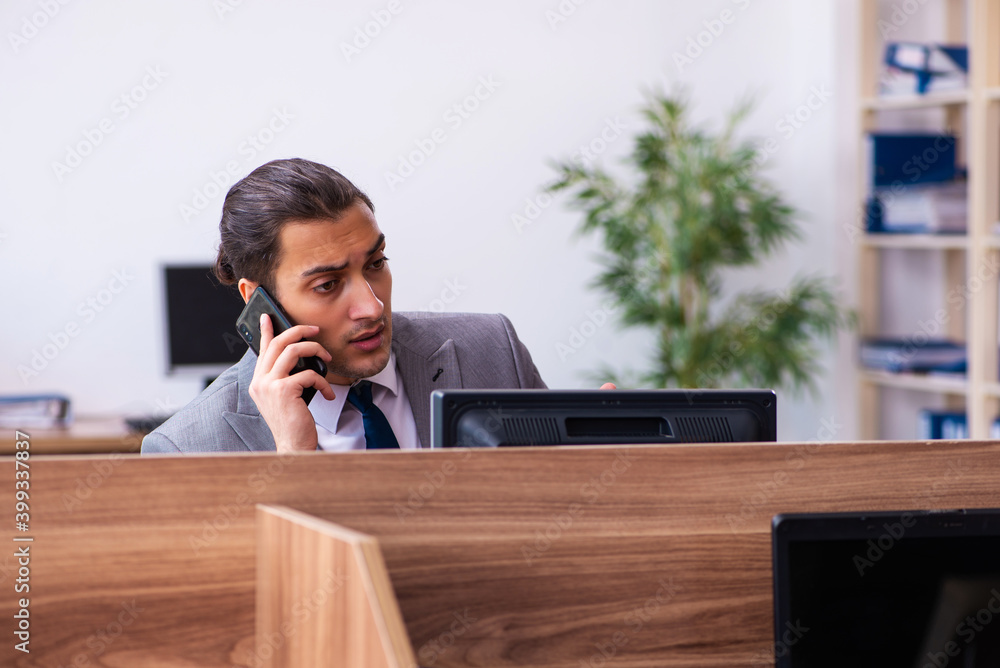 Young male employee working in the office Young male employee working in the office