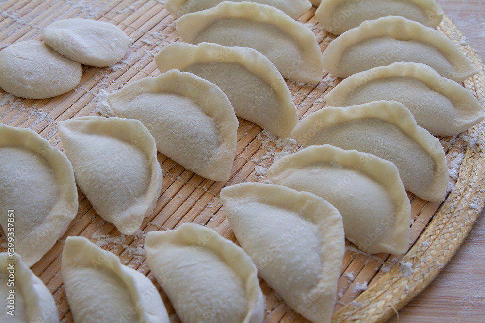 Freshly wrapped dumplings close up. Chinese food. Freshly wrapped dumplings close up. Chinese food.