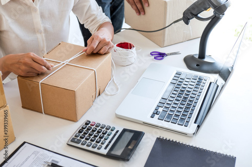 Small business owner delivery service and working packing box, business owner working checking order to confirm before sending customer in post office, Shipment Online Sales photo