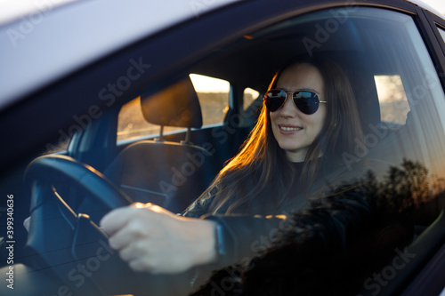Young businesswoman driving car in the evening