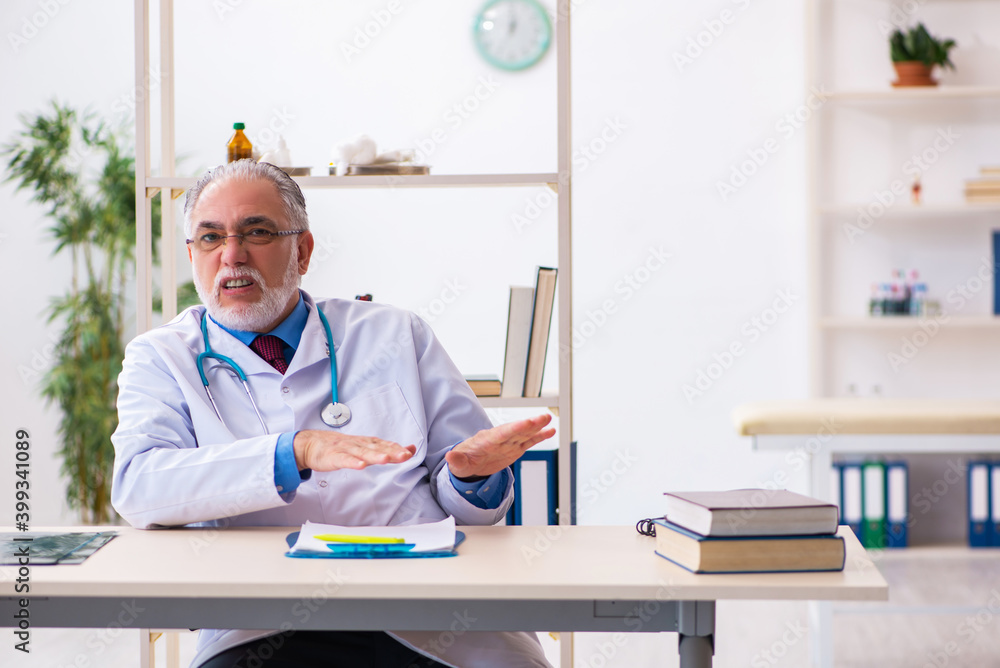 Old male doctor tired after night shift Old male doctor tired after night shift