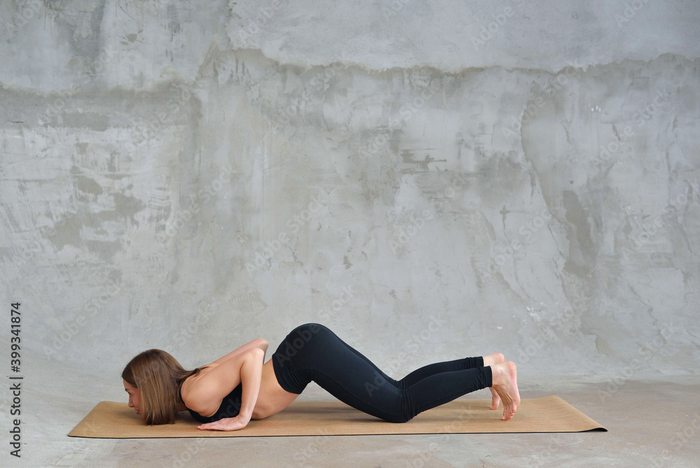 Obraz premium Sporty beautiful blond young woman in sportswear working out indoors, doing Eight-Limbed Posture, Ashtanga Namaskarasana on eco mat, full length